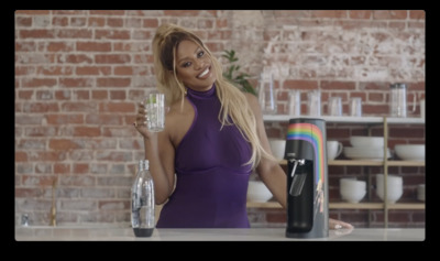 a woman in a purple dress holding a glass of water