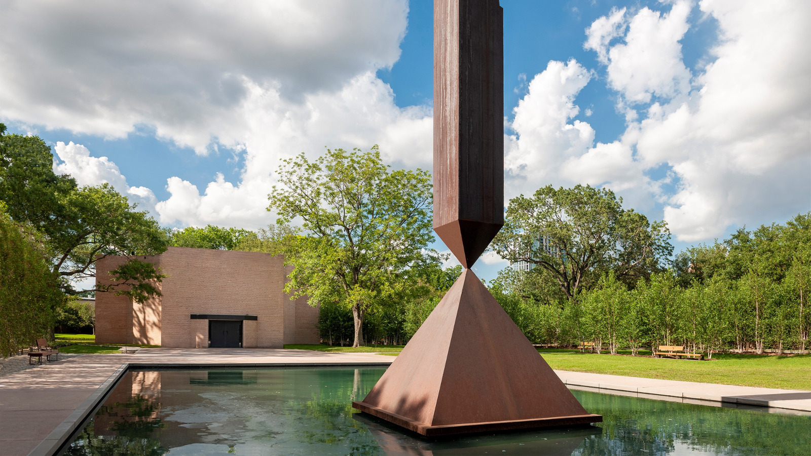 a sculpture in the middle of a pool of water