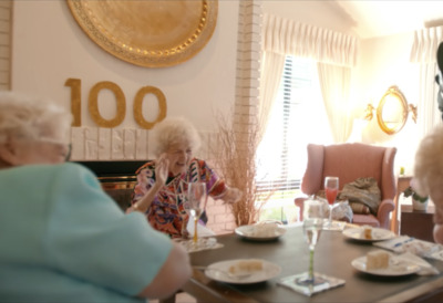 a group of elderly people sitting around a table