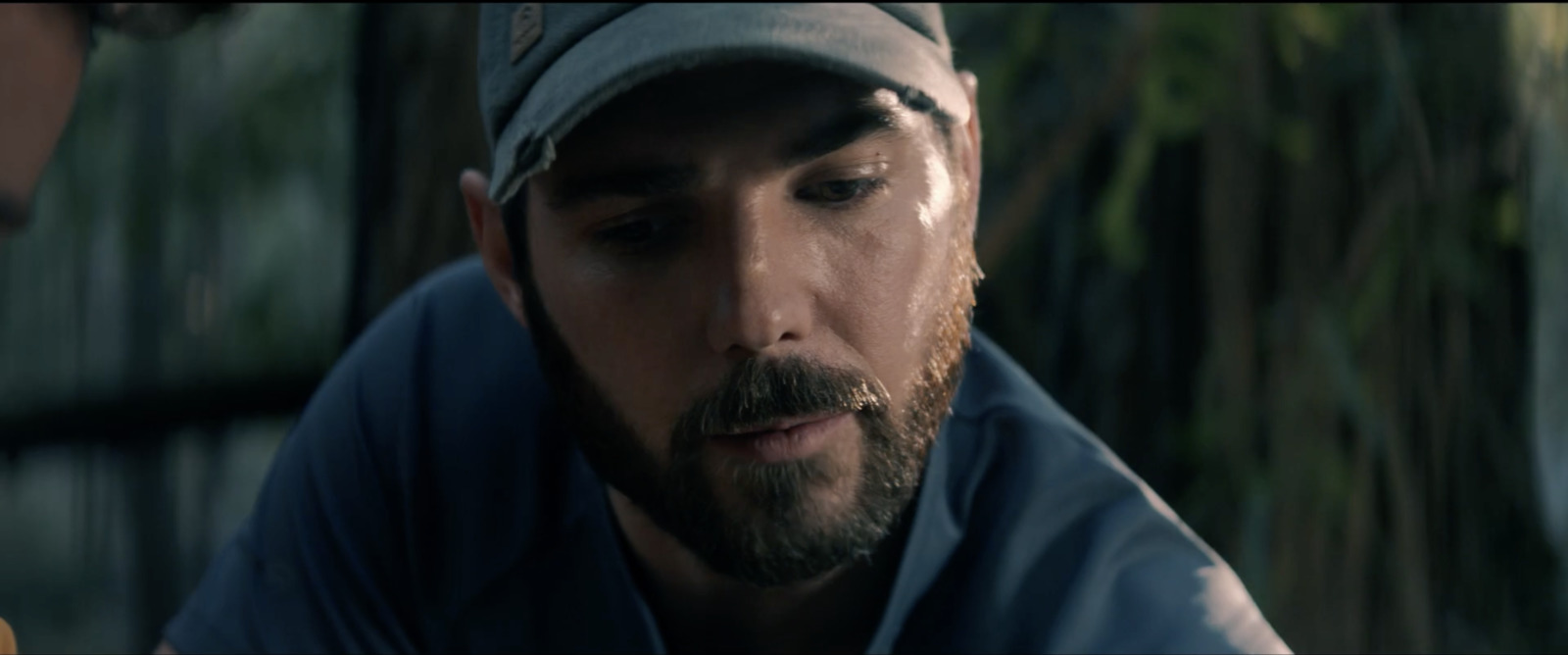 a man with a beard wearing a hat