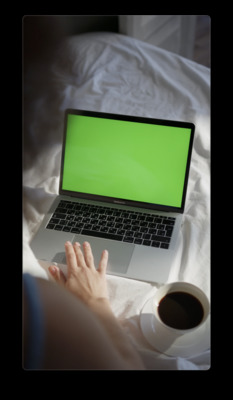 a person using a laptop with a green screen