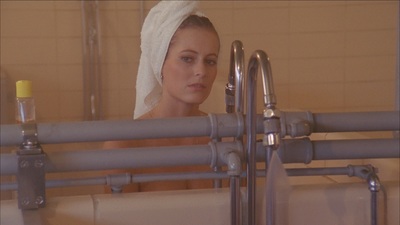 a woman with a towel on her head in a bath room