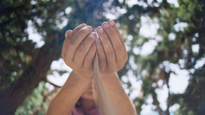 a person holding their hands up in the air