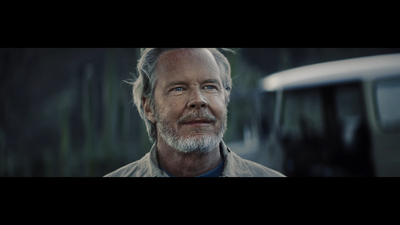 a man with a white beard and a blue shirt