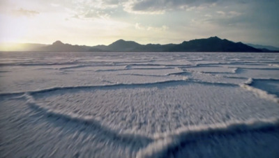 a large expanse of water with mountains in the background