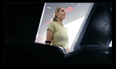 a woman standing in front of a computer monitor