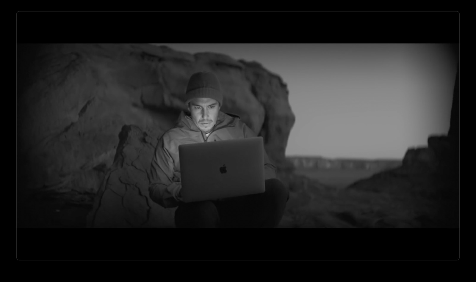 a man sitting in front of a laptop computer