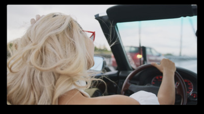 a woman driving a car on a street