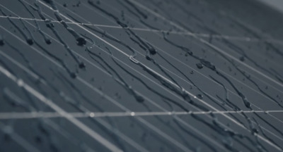 a black and white photo of lines and drops of water