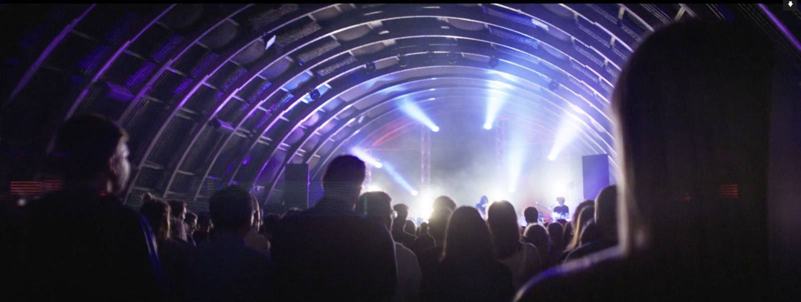 a group of people standing in front of a stage