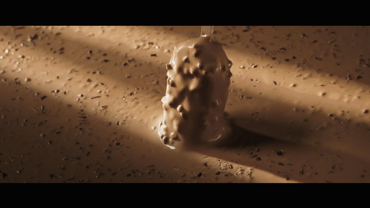 a candle that is sitting in the sand