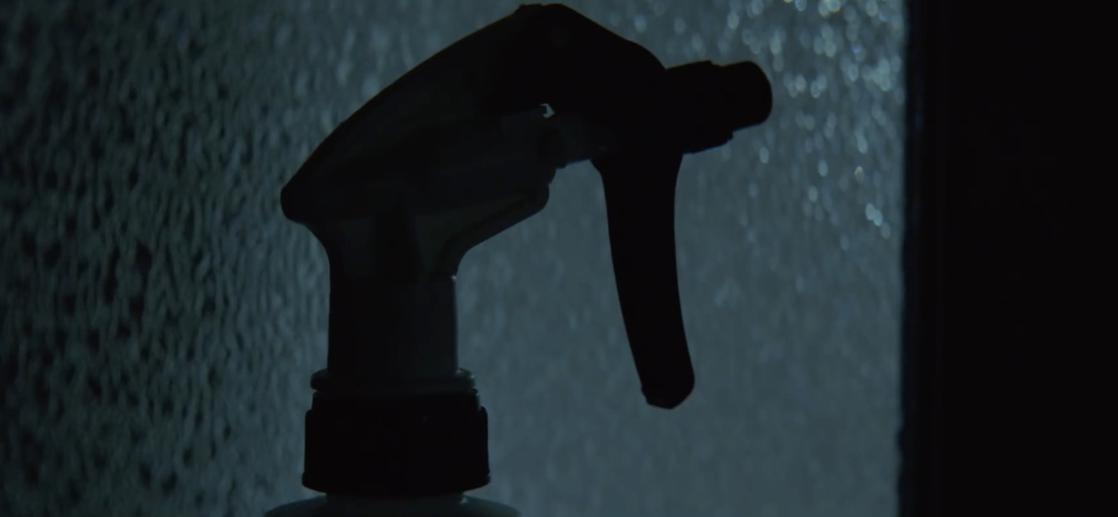 a close up of a spray bottle in the rain