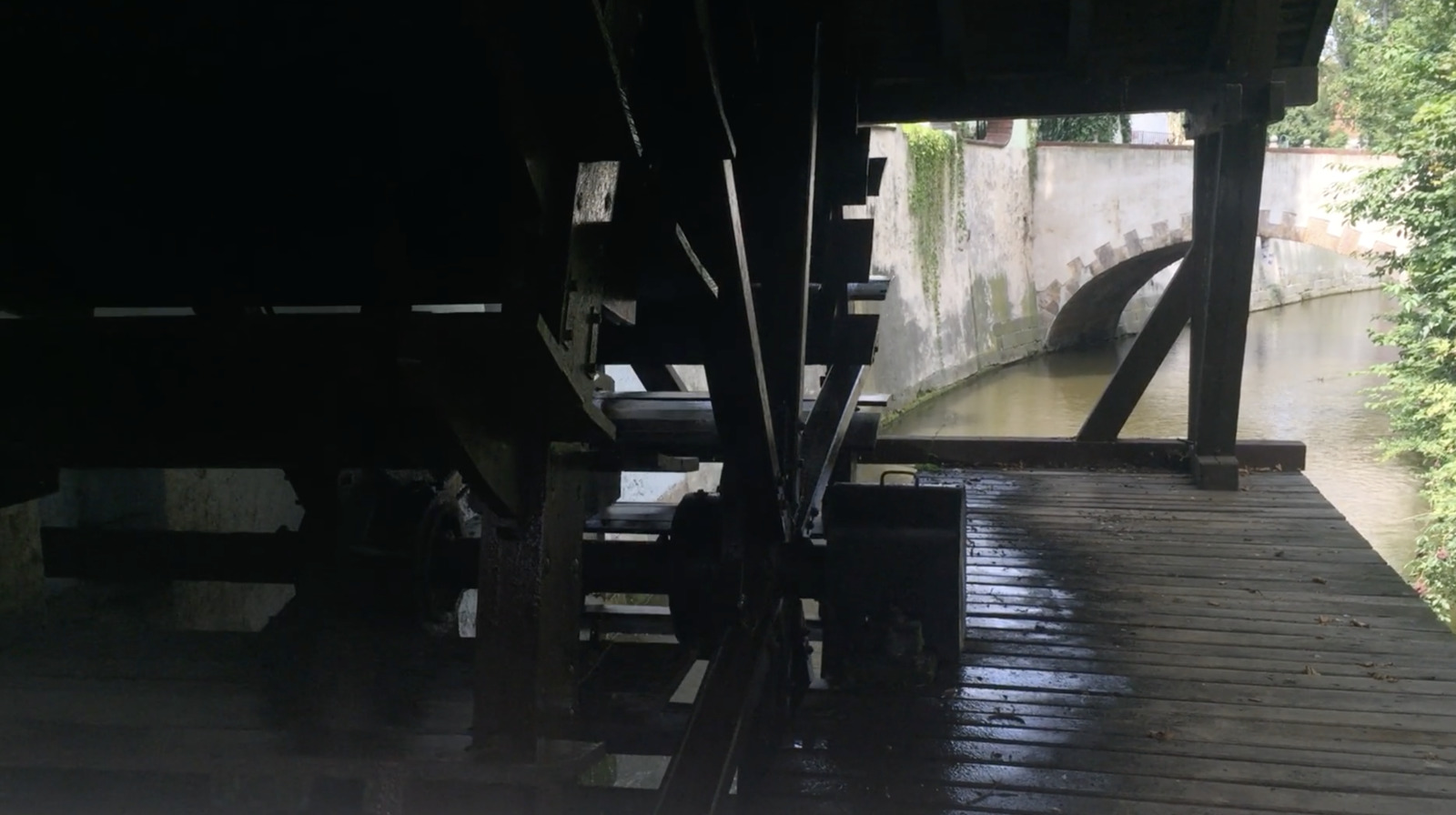 a view of a wooden bridge over a body of water