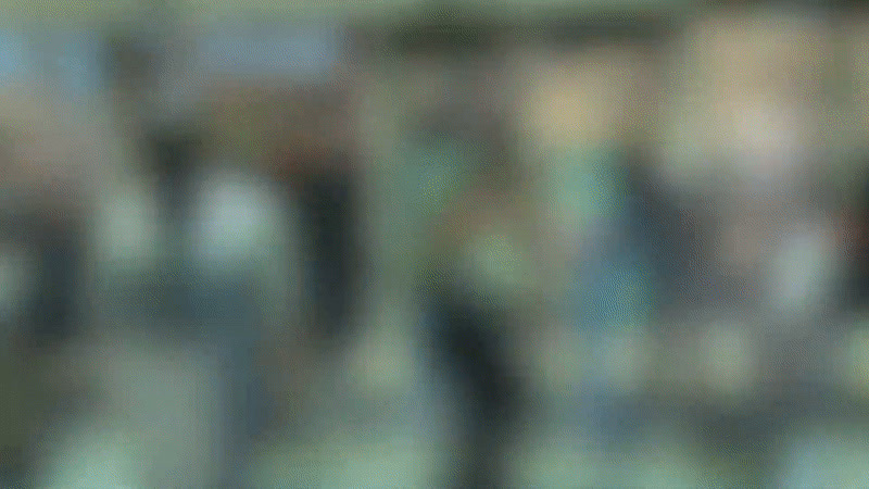 a blurry image of a person holding a cell phone