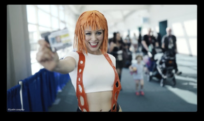 a woman with orange hair and a white top