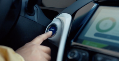 a person using a cell phone in a car