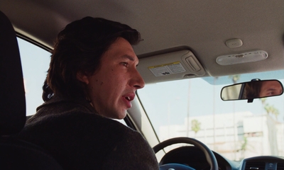 a man driving a car with a surprised look on his face