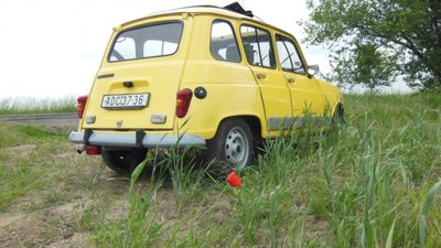 a small yellow van parked on the side of the road