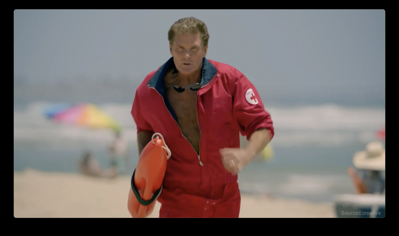 a man in a red swimsuit holding a life preserver