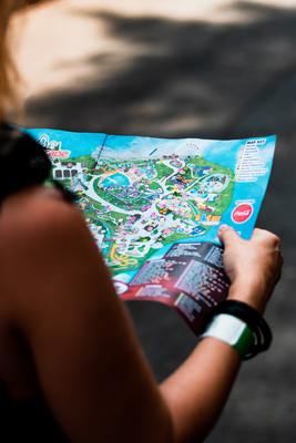 a woman holding a map of a park