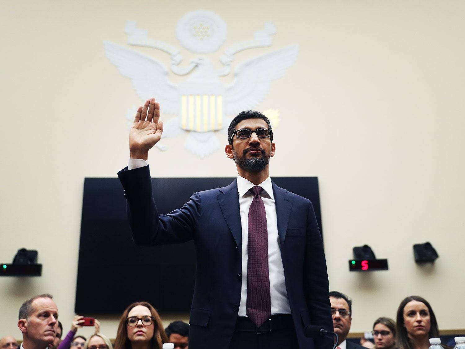 a man in a suit and tie giving a speech