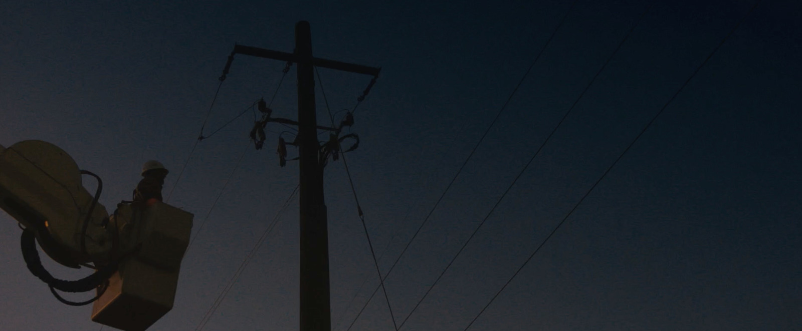 a street light and a telephone pole at night