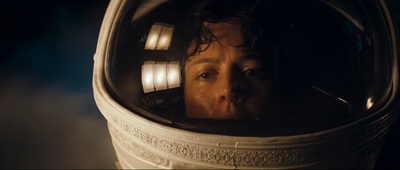 a man in a space suit looking into a mirror