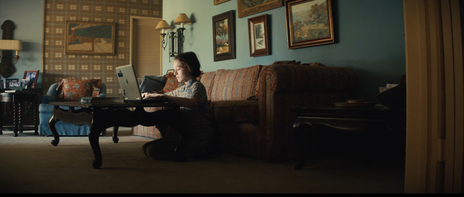 a woman sitting on a couch using a laptop computer