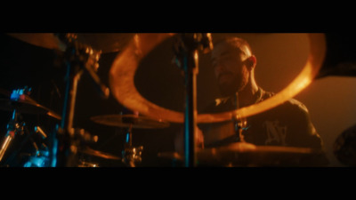 a man playing drums in a dark room