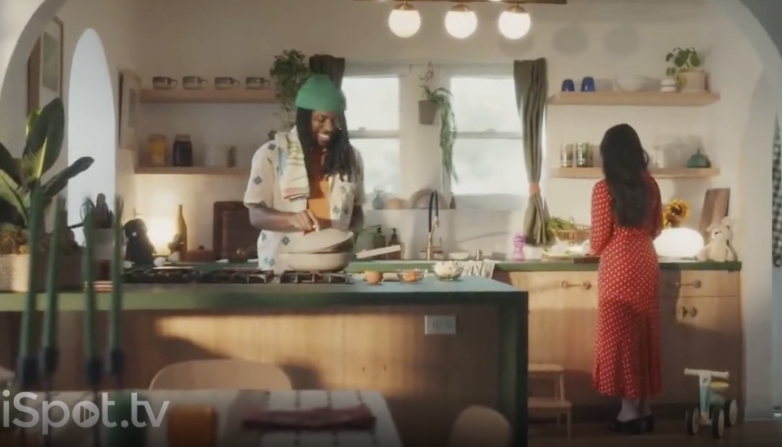 a woman standing in a kitchen next to a man