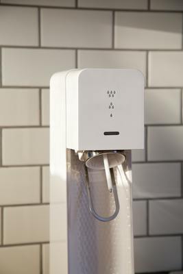 a water dispenser on a counter in a kitchen