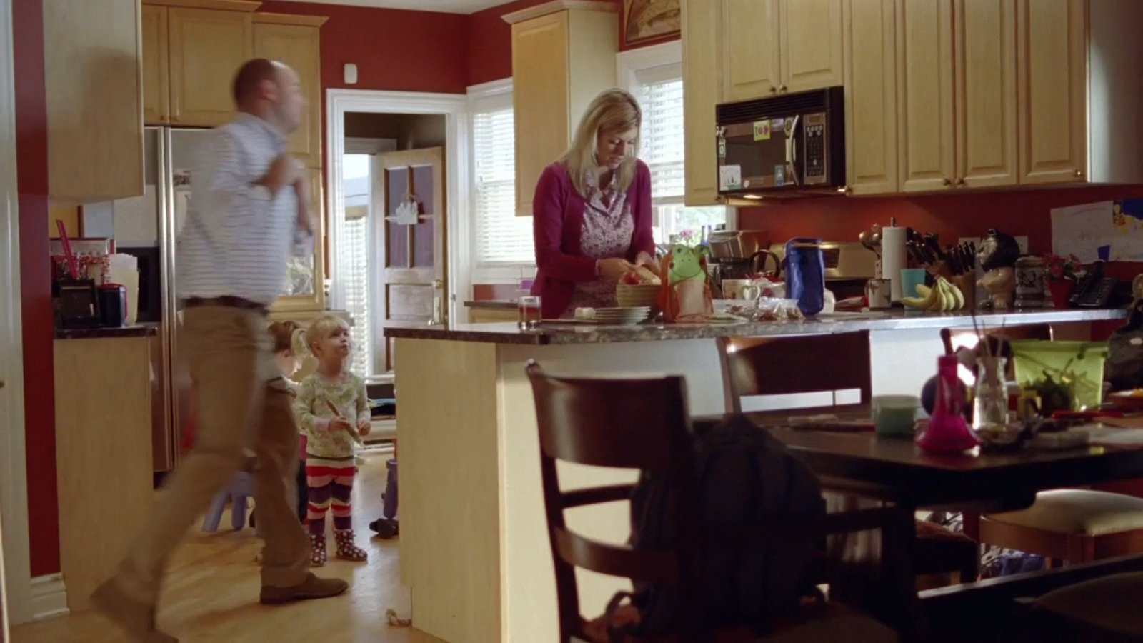 a man and a woman standing in a kitchen