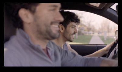 a couple of men sitting in a car