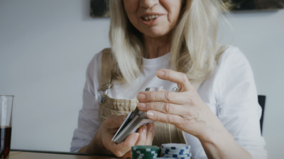 a woman sitting at a table holding a cell phone