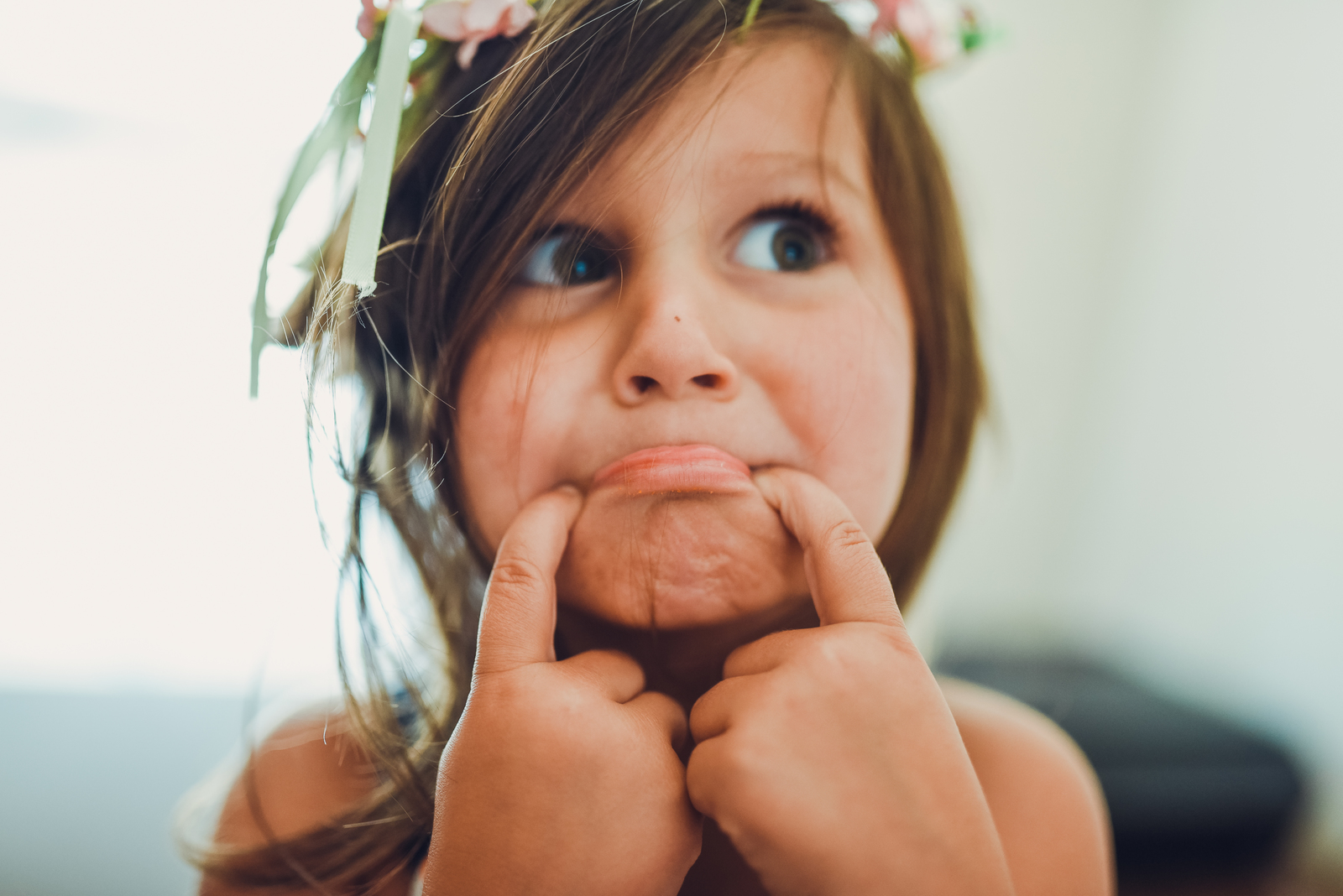 a little girl with a flower crown on her head