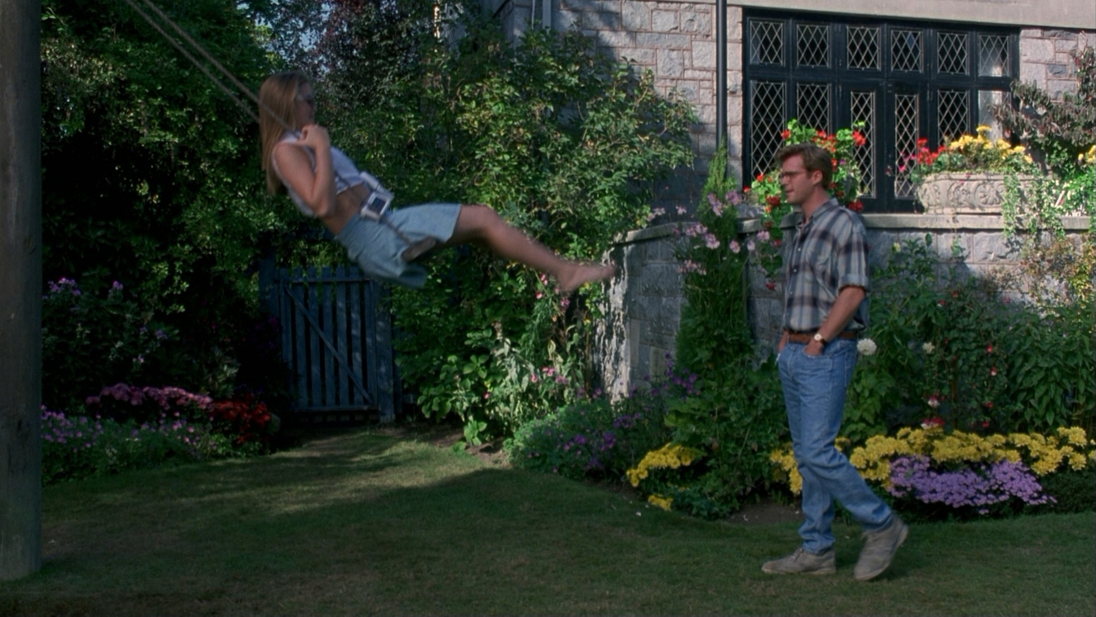 a man standing next to a woman in a yard