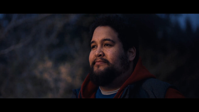 a man with a beard and a red hoodie