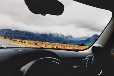 a view from inside a car of mountains and a road