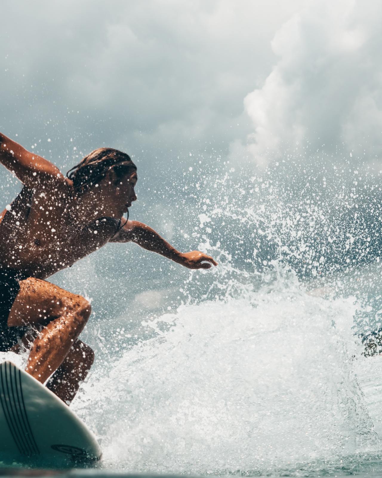 a man riding a wave on top of a surfboard