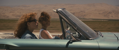 a woman sitting in a blue convertible car