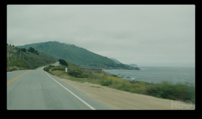 a view of the ocean from a moving car