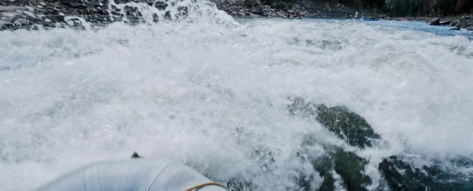 a man riding a wave on top of a surfboard