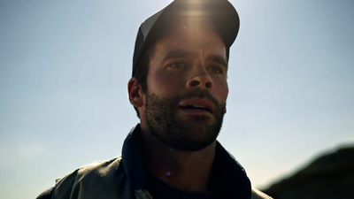 a man with a beard and a leather jacket