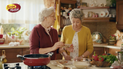 two women in a kitchen preparing food together