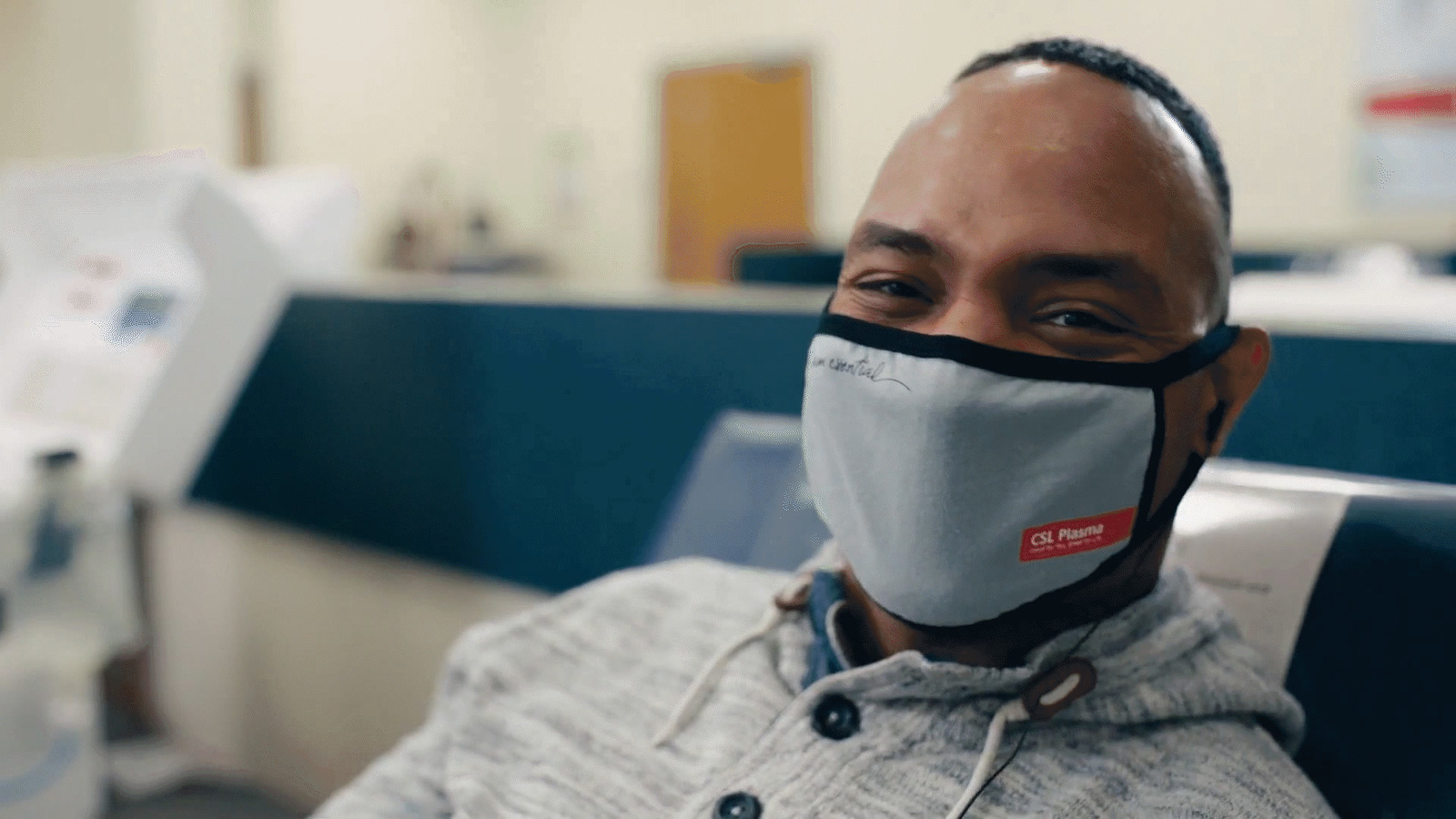 a man wearing a face mask in an office