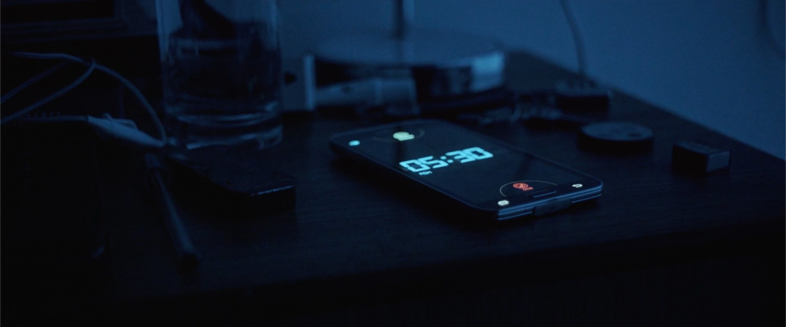 a cell phone sitting on top of a wooden table