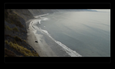 an aerial view of a beach and a cliff