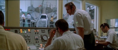 a group of men working in a control room