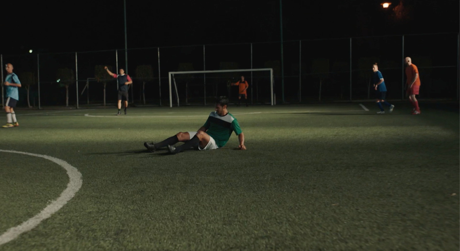 a soccer player is laying on the ground