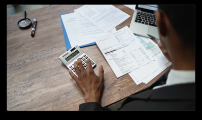 a man using a calculator at a desk